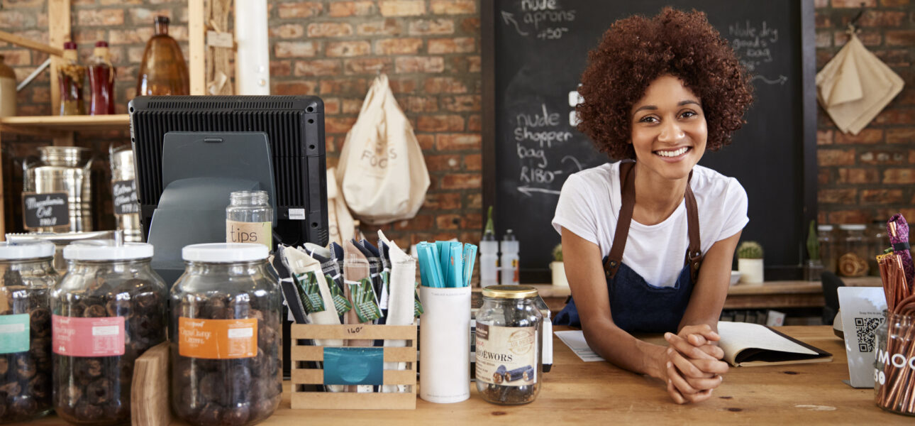 Portrait Of Female Owner Of Sustainable Plastic Free Grocery Store Behind Sales Desk